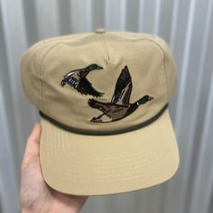 Made for the hunting enthusiast, our Ensenada Rope Hat - Wildlife - Ducks is crafted from 100% ripstop polyester and features an adjustable snap closure for the perfect fit. This hat is lightweight and durable, making it the perfect accessory to your morning duck blind adventures. 100% Ripstop Polyester Custom Pointer Design Adjustable Snap Closure Unisex Sizing Hunting Aesthetic, Duck Hat, Duck Blind, Hunter Outfit, Funky Hats, Quack Quack, Hat Ideas, Duck Hunting, Trotter