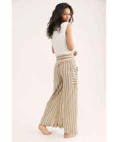 Perfect for any occasion, these effortless wide leg pants are featured in a textured, striped fabrication with exaggerated pockets and drawstring waistband in a high-rise silhouette. Elastic waistband Semi-sheer fabrication Effortless pull-on style Care/Import Machine Wash Cold Gentle Import Measurements for size small Waist: 28 in Rise: 14 in Inseam: 29 in Fabric Content: 100% Cotton Striped Linen Pants With Elastic Waistband, Striped Beach Pants With Elastic Waistband, Beach Striped Pants With Elastic Waistband, Chic Striped Wide Leg Pants For Loungewear, Casual Striped Linen Wide Leg Pants, Chic Striped Bottoms With Elastic Waistband, Striped Wide-leg Pants With Elastic Waistband, Striped Wide Leg Trousers With Elastic Waistband, Chic Striped Pants With Elastic Waistband