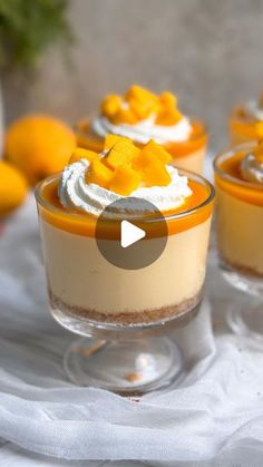 three desserts in small glass dishes with whipped cream and orange zest on top