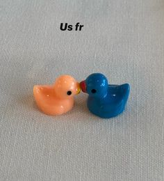 two small plastic birds sitting next to each other