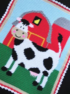 a close up of a knitted placemat with a cow