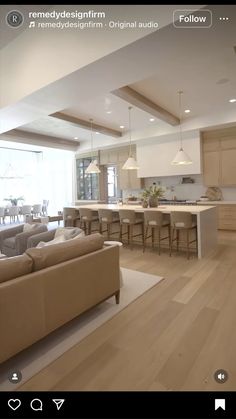 a living room filled with furniture next to a kitchen