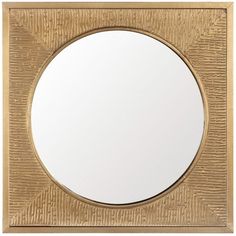 a round mirror sitting on top of a wooden table