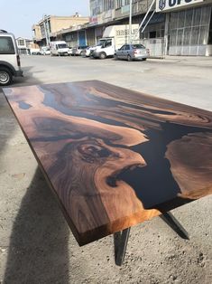 a wooden table sitting in the middle of a street