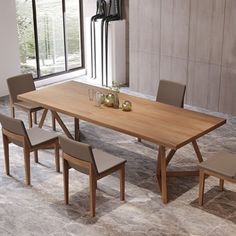 a wooden table with chairs around it in front of a large window on the floor