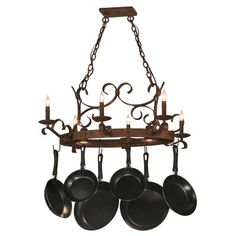 an iron chandelier with pots and pans hanging from it's arms