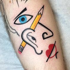 a man's leg with a pencil and eye tattoo on it