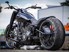 a black motorcycle parked in front of a building