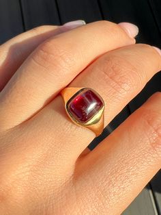 Antique 18k yellow gold ring from the United Kingdom. This signet ring features a vibrant synthetic ruby cabochon. Great antique condition Size: 7.5 resizable* Weight: 3.5 grams Band: 11.1 mm (front), 1.7 mm (back) Synth Ruby: 8.3 mm x 10.0 mm Hallmarks:18CT Ruby Cabochon Ring, Cabochon Ring, 18k Yellow Gold Ring, Yellow Gold Ring, Signet Ring, Yellow Gold Rings, Gold Ring, United Kingdom, Gold Rings