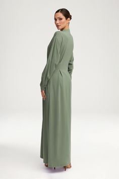 Add luxury and sophistication to your wardrobe with our Ivy Jersey Button Down Maxi Dress. This dress features a button-down design, removable belt, and cuffed sleeves for a touch of elegance. The princess seams create a flattering silhouette, making it a versatile and timeless piece for any occasion. Model is 5'8 wearing size XS/58". Button Down Maxi Dress, Jersey Hijab, Princess Seams, Princess Seam, The Princess, Beautiful Gift Boxes, Cuff Sleeves, Timeless Pieces, Ivy