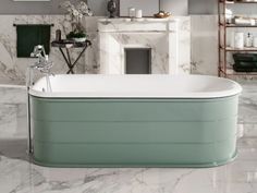 a bath tub sitting next to a fireplace in a room with marble floors and walls