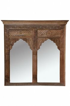 an ornate wooden cabinet with mirrors on it