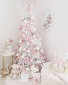 a cute white Christmas tree styled with pastel pink, green and white ornaments, pink hearts, snowflakes, stars and a bow on top Pink And White Christmas Tree, Pink And White Christmas, A Pink Christmas, Pink Xmas, Candy Land Christmas Decorations Diy, Pink Ornament, Candy Land Theme