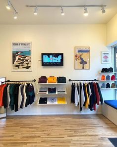 the inside of a clothing store with clothes hanging on racks