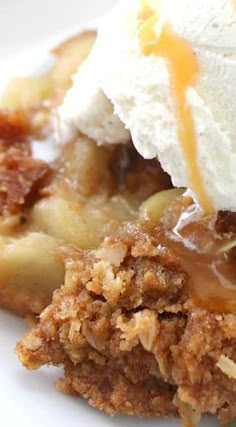 a piece of pie with ice cream and caramel sauce on top is sitting on a white plate