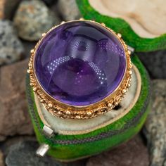 This fabulous vintage cocktail ring features a round cabochon amethyst in a bezel that is accented with gold wire and bead work. The ring is crafted in patinated 14k yellow gold and is currently a size 6.75. This amethyst has some lovely birthmarks in the stone. Lilac Jewelry, Antique Cocktail Ring, Gemstones Rings, Purple Gemstones, Amethyst Cocktail Ring, Pearl Rings Vintage, Amethyst Set, Vintage Cocktail Ring, Peridot Jewelry