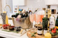 a table topped with lots of wine bottles and glasses filled with different types of drinks