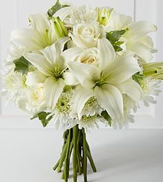 a bouquet of white flowers sitting on top of a table