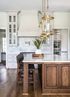 a large kitchen with an island in the middle