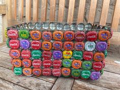 a bag filled with lots of candy sitting on top of a wooden table next to a fence