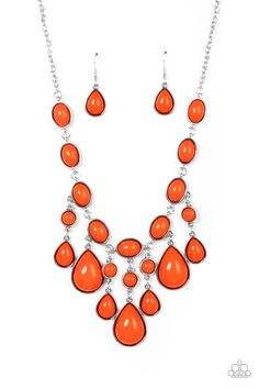 an orange necklace and earring set with dangling drops on the front, hanging from a silver chain