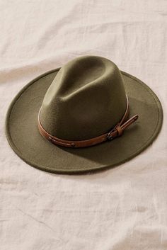 One size fits all belted wide brim hat Luxury Bohemian Felt Hat With Flat Brim, Luxury Artisan Natural Color Hats, Olive Green Rancher Hat, Luxury Bohemian Natural Fedora, Luxury Wide Brim Felt Hat For Travel, Luxury Casual Brimmed Felt Hat, Affordable Brimmed Felt Hat For Fall, Luxury Brown Bohemian Felt Hat, Luxury Workout Clothes