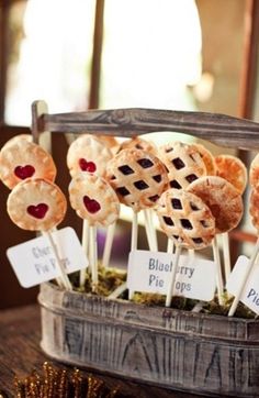 some pies are on sticks with blueberry toppings