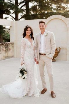 a bride and groom posing for a wedding photo