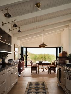 an open kitchen and dining room with sliding glass doors