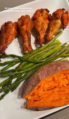 chicken wings, asparagus and sweet potato on a plate