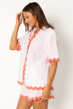 DETAILS   This season, don't forget to pack the perfect vacation-ready look. Our button down shirt is made with a v neckline and collared detail. Its short sleeves feature a vibrant melon contrast trim and hem, all while providing an oversized fit for maximum comfort.    button down shirt   v neckline  collared  short sleeves  melon contrast trim and hem  oversized fit  unlined   material - 52% cotton / 48% linen    SIZING    model is 5' 8" and wears a Size S  model stats: bust -  86  cm, waist Summer V-neck Shirt For Vacation, Orange V-neck Summer Shirt, Orange V-neck Shirt For Summer, Summer Orange V-neck Shirt, Orange Short Sleeve Shirt For Vacation, Orange Collared Tops For Summer, Orange Short Sleeve Camp Shirt For Vacation, Orange Collared Summer Blouse, Orange Short Sleeve Camp Shirt For Beach