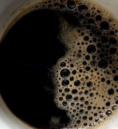 a close up view of a cup of coffee with liquid in the top and bottom