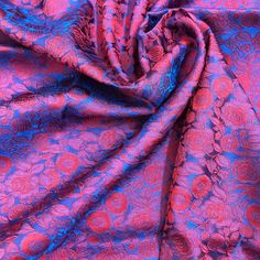 a purple and blue fabric with flowers on it