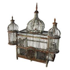 an old bird cage with two birds in it's top and one on the bottom