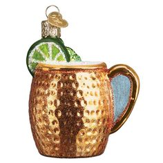 a glass ornament in the shape of a mug with a slice of lime