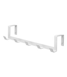 a white wall mounted shelf with three hooks