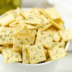 a white bowl filled with crackers on top of a table