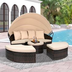 an outdoor patio furniture set near a swimming pool