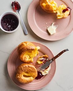 two plates with pastries and jam on them