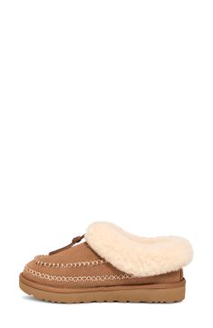 Contrast stitching stylishly coordinates with the fluffy genuine-shearling cuff of this supple suede clog that rests atop a plush foam footbed. 1 1/4" heel Cushioned footbed Shearling may be sourced from Australia, Ireland, Spain, the UK or the USA. See packaging for confirmed country of origin Textile and genuine-shearling upper/UGGplush wool-blend lining/synthetic sole Imported Winter Sheepskin Clogs With Suede Lining, Brown Sheepskin Slippers For Fall, Brown Shearling Clogs For Winter, Brown Shearling Slippers With Faux Fur Lining, Winter Brown Shearling Clogs, Ugg Tasman, Suede Clogs, Fabric Gift Bags, Womens Clogs