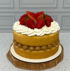 there is a cake that has strawberries on top