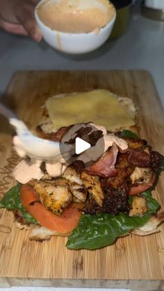 the person is cutting up some food with a knife on a wooden board next to a bowl