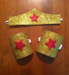 two pieces of gold glitter with red stars on them