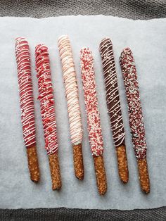 five different types of donuts on a piece of paper with sprinkles