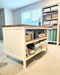 an organized office space with drawers and shelves