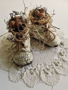 two old shoes are sitting on a lace doily with eggs in the top and bottom