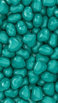 a close up view of candy pebbles in teal green color, texture or background