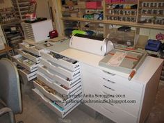 an office desk with lots of drawers and papers