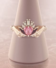 Exquisite and delicate Claddagh ring with pink sapphire heart and baguette diamonds crown. Traditional irish promise ring, beautiful symbol of love (heart), friendship (hands) and loyalty (crown). Modernized design of this ring makes it perfect heirloom piece of our days, that will become your real heritage. About this item: -Pink sapphire (~0,5ct) and diamonds G-H color.Total carat weight ~ 0.55 -Heart stone can be customized, please feel free to write me for variations. -Solid 10K Rose, Yellow Pink Sterling Silver Wedding Jewelry With Accent Stones, Pink Sapphire Jewelry For Promise Occasion, Heirloom Pink Diamond Promise Ring, Pink Sapphire Jewelry For Promise, Pink Morganite Jewelry For Promise, Wedding Jewelry With Pink Sapphire Birthstone, Pink Sapphire Promise Jewelry, Pink Sapphire Birthstone Jewelry For Wedding, Unique Pink Wedding Rings