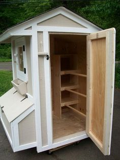 an outhouse with the door open and shelves inside